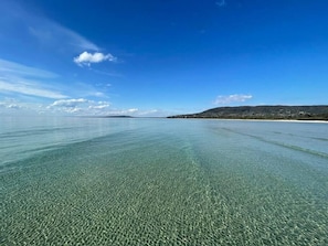 Enjoy breathtaking views of the sea and surrounding hills from this serene coastal retreat.