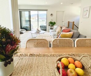 Relax in this stylish living room with a balcony access, dining table, and comfortable seating area.