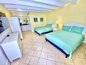 A hotel room with two beds, a desk, a chair, and a small table. - Pet-friendly, 3 Blocks to Beach, Pool, #304 (Atlantic Beach)