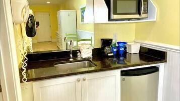 Fridge, microwave, coffee/tea maker, cookware/dishes/utensils
