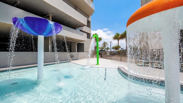 A swimming pool with water features, including a fountain and a water sculpture. - Beautiful 3-Bedroom with a Balcony - Seawind 905 (Gulf Shores)
