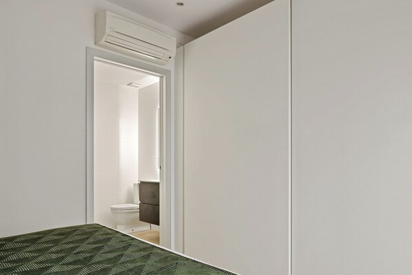 A narrow hallway leading to a bathroom with a toilet and a shower. - Easo Suite 7 by FeelFree Rentals (San Sebastian)