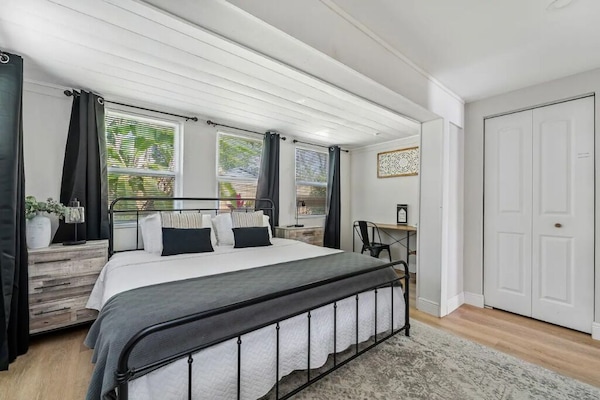 Relax in this serene bedroom with a king bed and workspace.