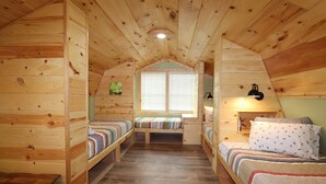A wooden cabin with two bunk beds, a small table, and a window with blinds. - Maple Ridge Creek in the North Georgia Mountains (Morganton)