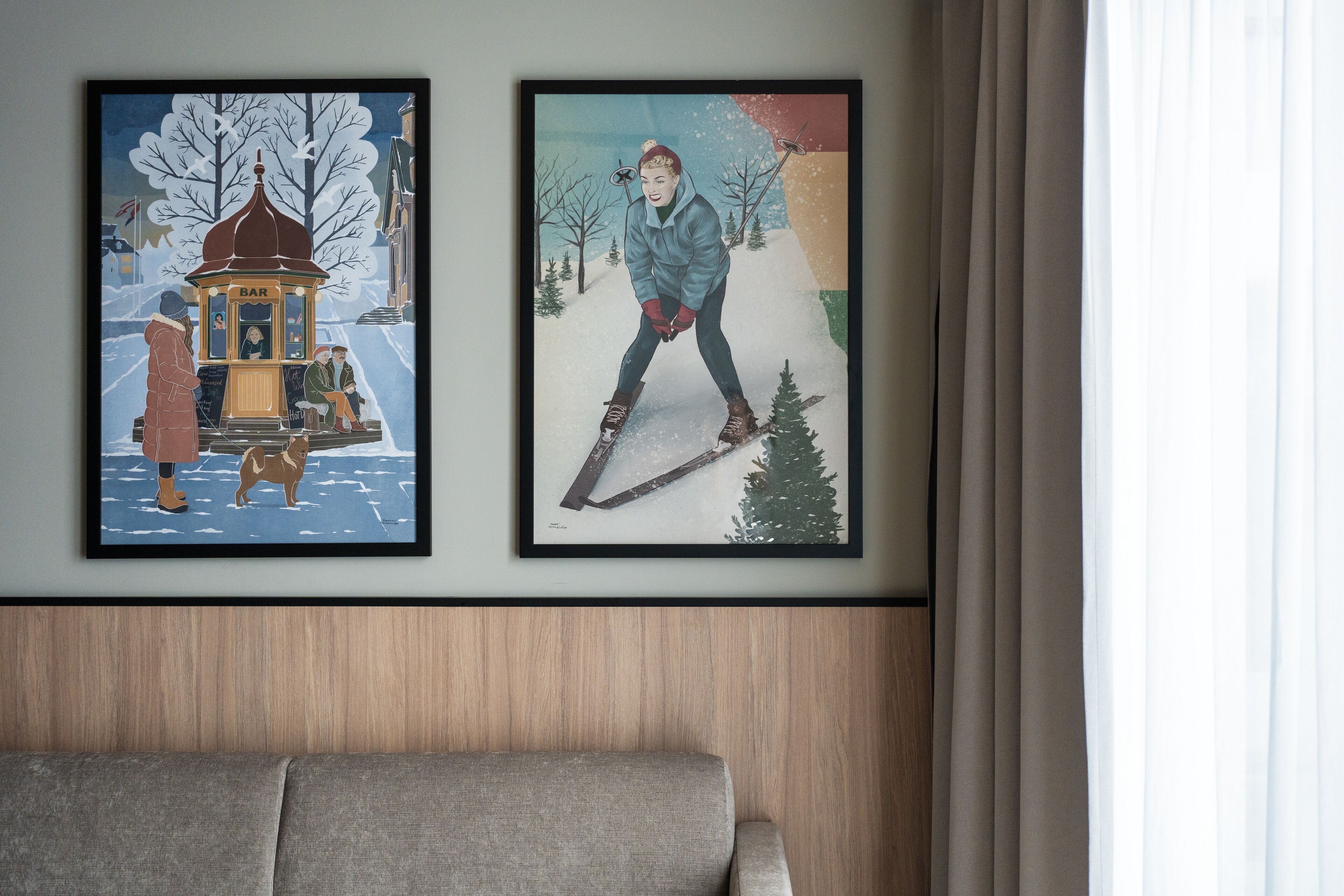 Two framed artworks on a wall above a sofa.