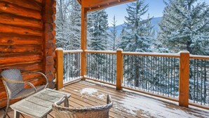 A wooden cabin with a balcony overlooking a snowy forest. - Spacious 7BR Lodge with Mountain Views! (Breckenridge)