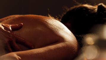 A dimly lit room with a person lying down, suggesting a private space.