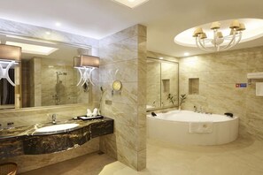 A modern bathroom with a large mirror, a freestanding bathtub, and a marble vanity. - Long Tai Hotel (Wengyuan)