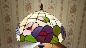 A wooden desk with a stained glass lamp. - AH #18 · AH #18 King/Jacuzzi Suite/Fridge/Micro (Wabasha)