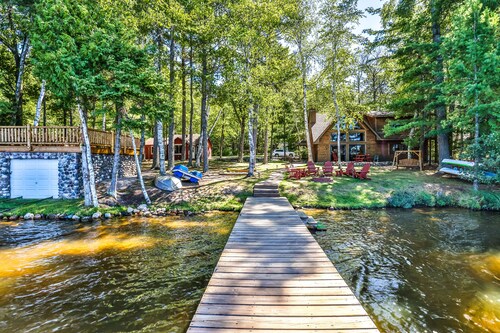 Charming, lakefront home with a gas fireplace, docks, firepit, & full kitchen