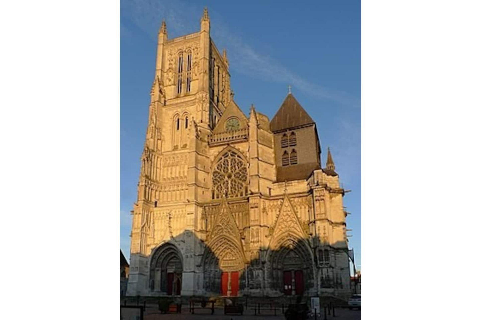 A large cathedral with a tall tower, large arched windows, and a prominent rose window.