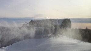 A snow-covered landscape with a large, cylindrical structure, possibly a storage or processing facility, surrounded by snow and mist. - Slopeside ski in/out 1 bedroom condo with parking on site! (Snowshoe)