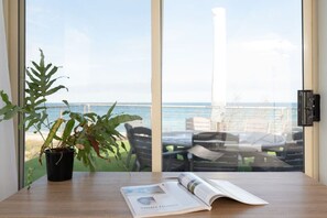 Enjoy a peaceful retreat with a serene sea view, a comfortable reading nook, and a clean, simple design.