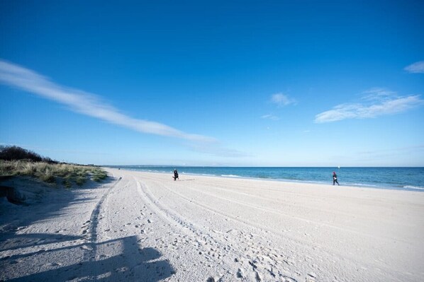 Enjoy a serene beach experience with expansive views and a sense of tranquility.