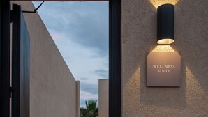A pathway leading to a wellness suite with a sign on the wall. - The Lodge Mallorca - Small Luxury Hotels (Sa Pobla)