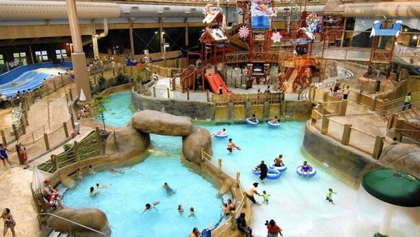 An indoor water park with multiple pools, slides, and play areas. - The Green Monster: Indoor Slide+Bar+Near Camelback (Mount Pocono)