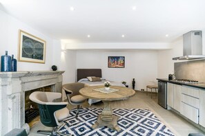 A modern living room with a fireplace, a round coffee table, and a sofa.