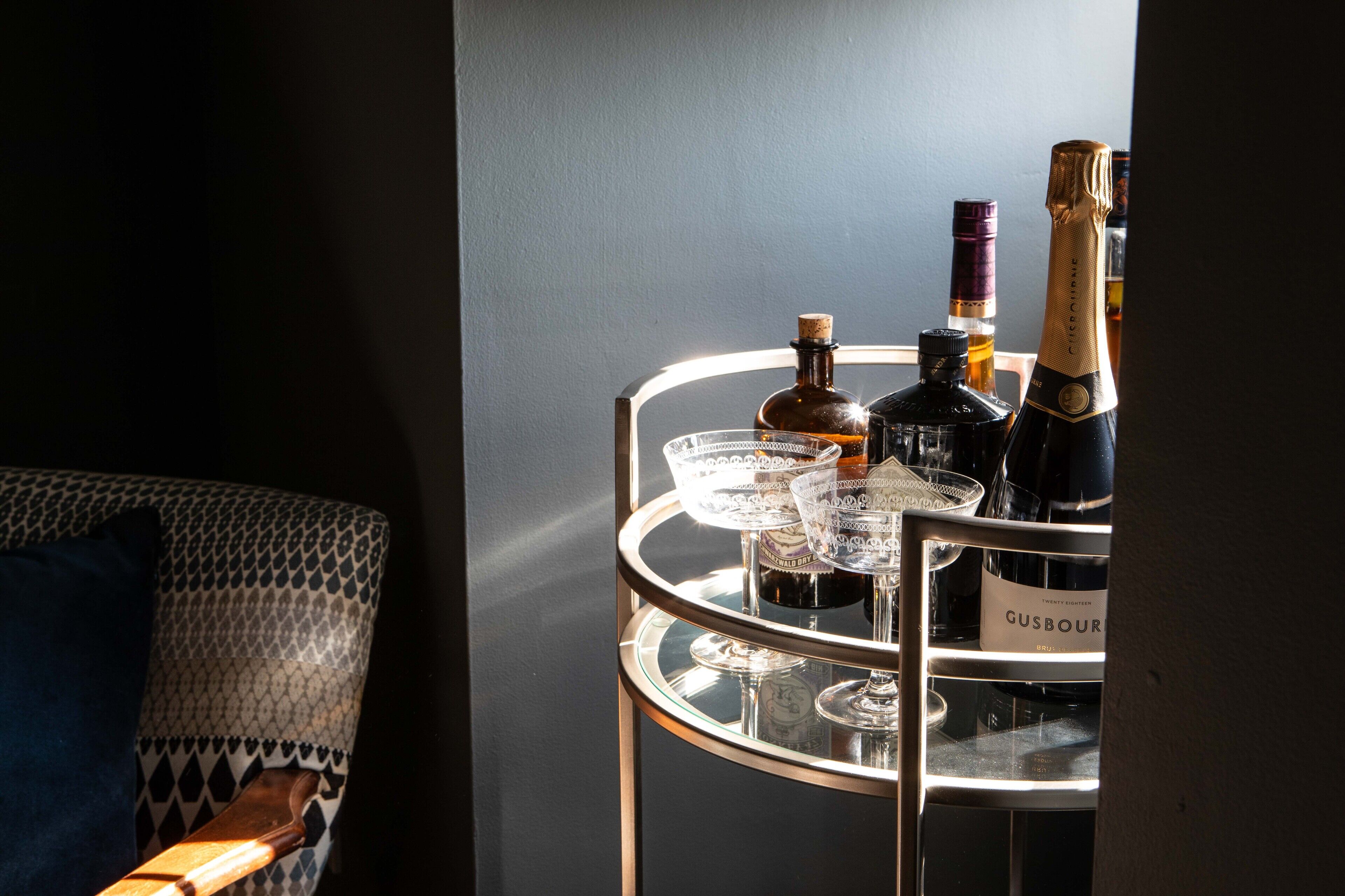 A bar area with a glass display case containing bottles and glasses.