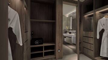 A walk-in closet with wooden shelving, a vanity with a mirror, and a robe hanging on the right.