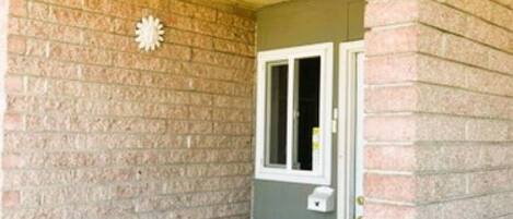 A brick exterior with a sign reading "OFFICE" and a door.