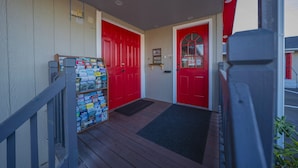 A wooden porch with a red door and a mailbox. - Oyo Hotel Portland Or Near Airport (Portland)