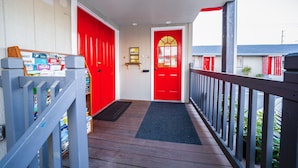 A wooden deck with a red door and a mailbox. - Oyo Hotel Portland Or Near Airport (Portland)