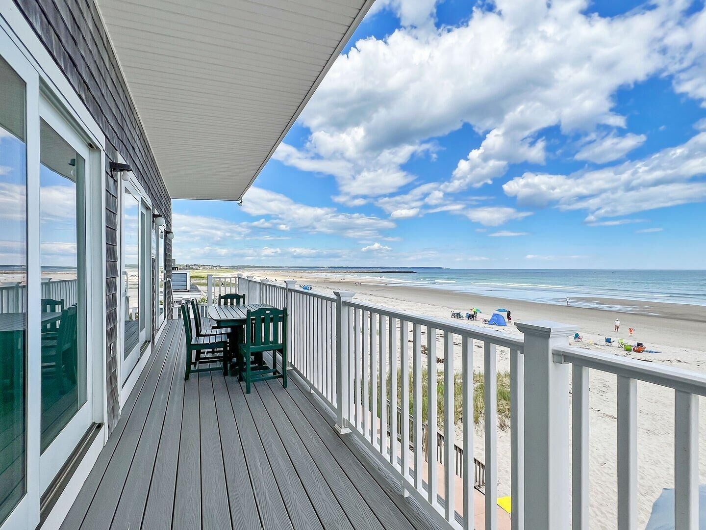 A wooden deck with a view of the beach.