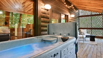 Relax in a serene hot tub surrounded by a wooden deck and seating area.