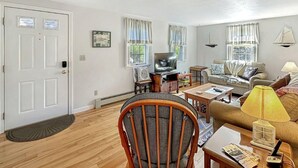 A living room with a television, sofa, and a chair. - Family Retreat at York Beach (York Beach)