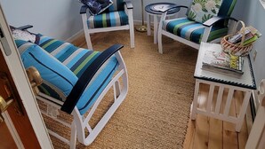 A cozy living room with striped armchairs, a small table, and a floor lamp. - Family Retreat at York Beach (York Beach)