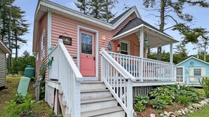 A pink house with a white porch and steps leading to the entrance. - Lighthouse - Q991 (Cape Neddick)