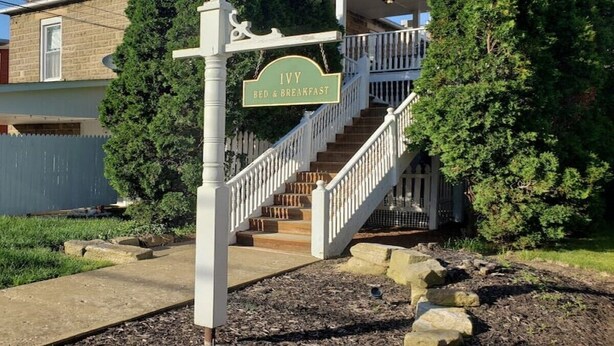 A residential property with a sign reading "Ivy Bed & Breakfast" and a staircase leading to a porch. - The Ivy of Dresden (Dresden)