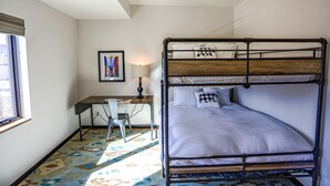 A bunk bed with a desk and chair, a lamp, and a framed picture on the wall. - Modern Townhouse on the River w/AC, Roof Top Deck (Durango)