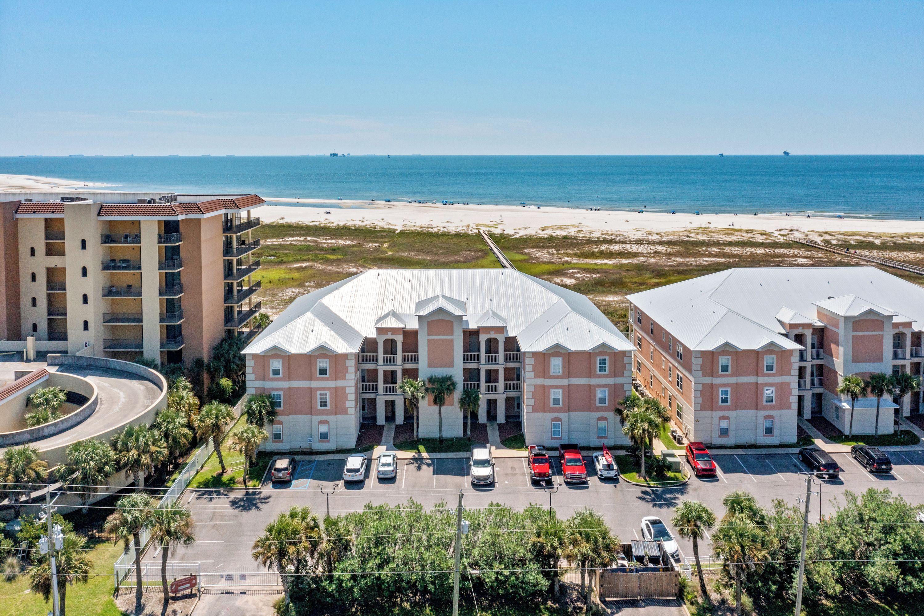 A hotel with a central courtyard, multiple floors, and a parking lot.
