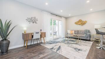 Relax in this stylish living room with a sofa, desk, and coffee table, surrounded by beautiful views and decorative art.