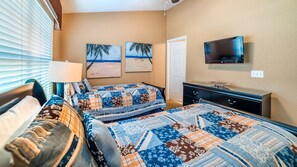 A bedroom with a bed, a dresser, a TV, and two paintings on the wall. - New Listing! Windsor Hills Resort, 3mi to Disney & 12mi to Universal - GRH438827 (Kissimmee)