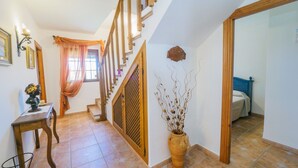 A staircase with wooden railings leading to a bedroom.