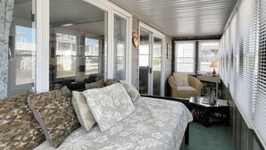A cozy room with a sofa, a chair, and a table with a lamp. - Sweet Dreams (Wells)