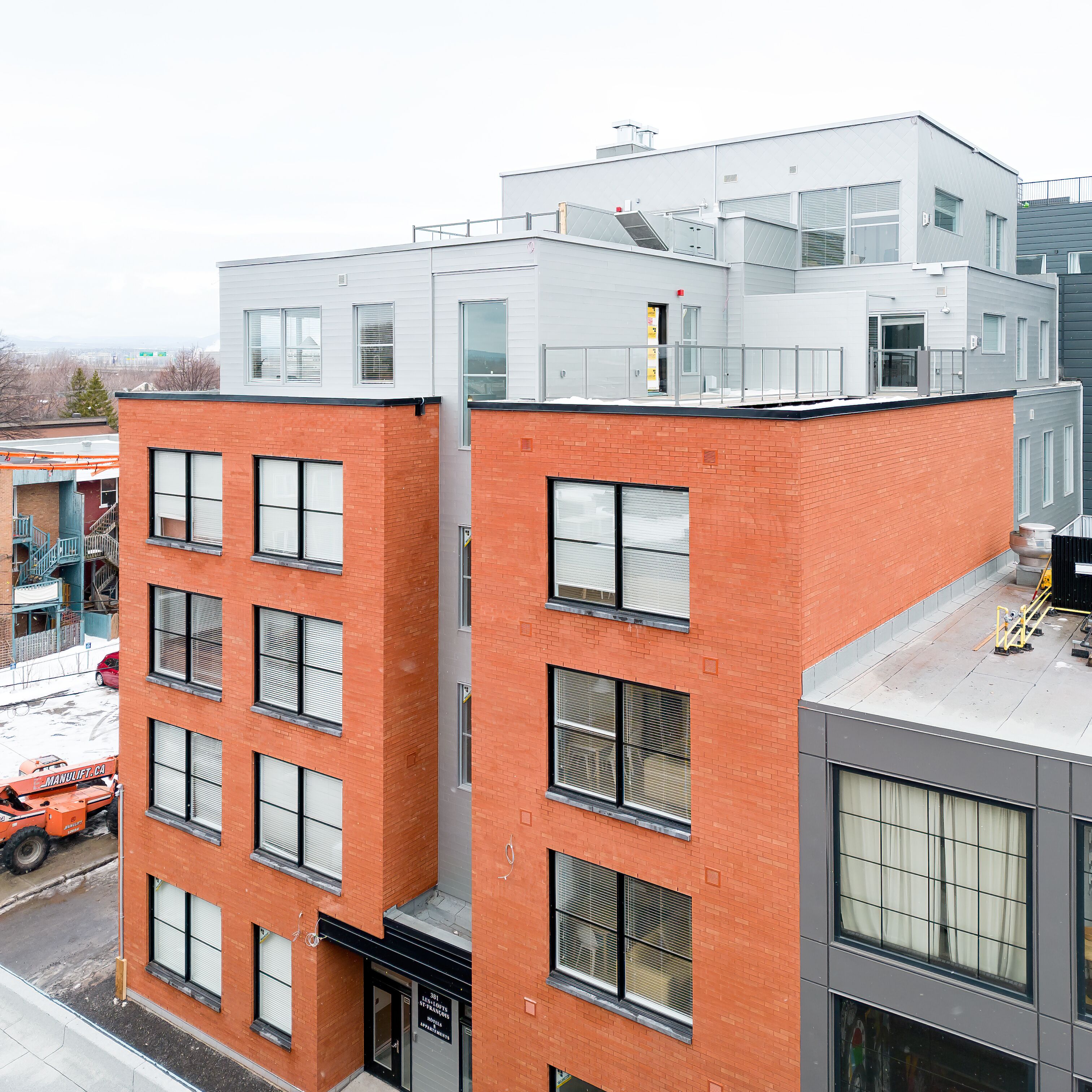 A multi-story building with a mix of brick and modern glass facades.