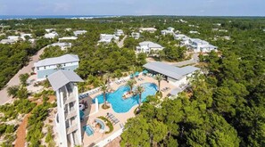 An aerial view of a resort with multiple buildings, a central swimming pool, and surrounding greenery. - Beautiful 3 Bedroom Beach Home in Santa Rosa Beach on 30A (Santa Rosa Beach)