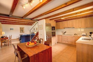 Enjoy meals in the kitchen with a dining area featuring a wooden table and chairs.
