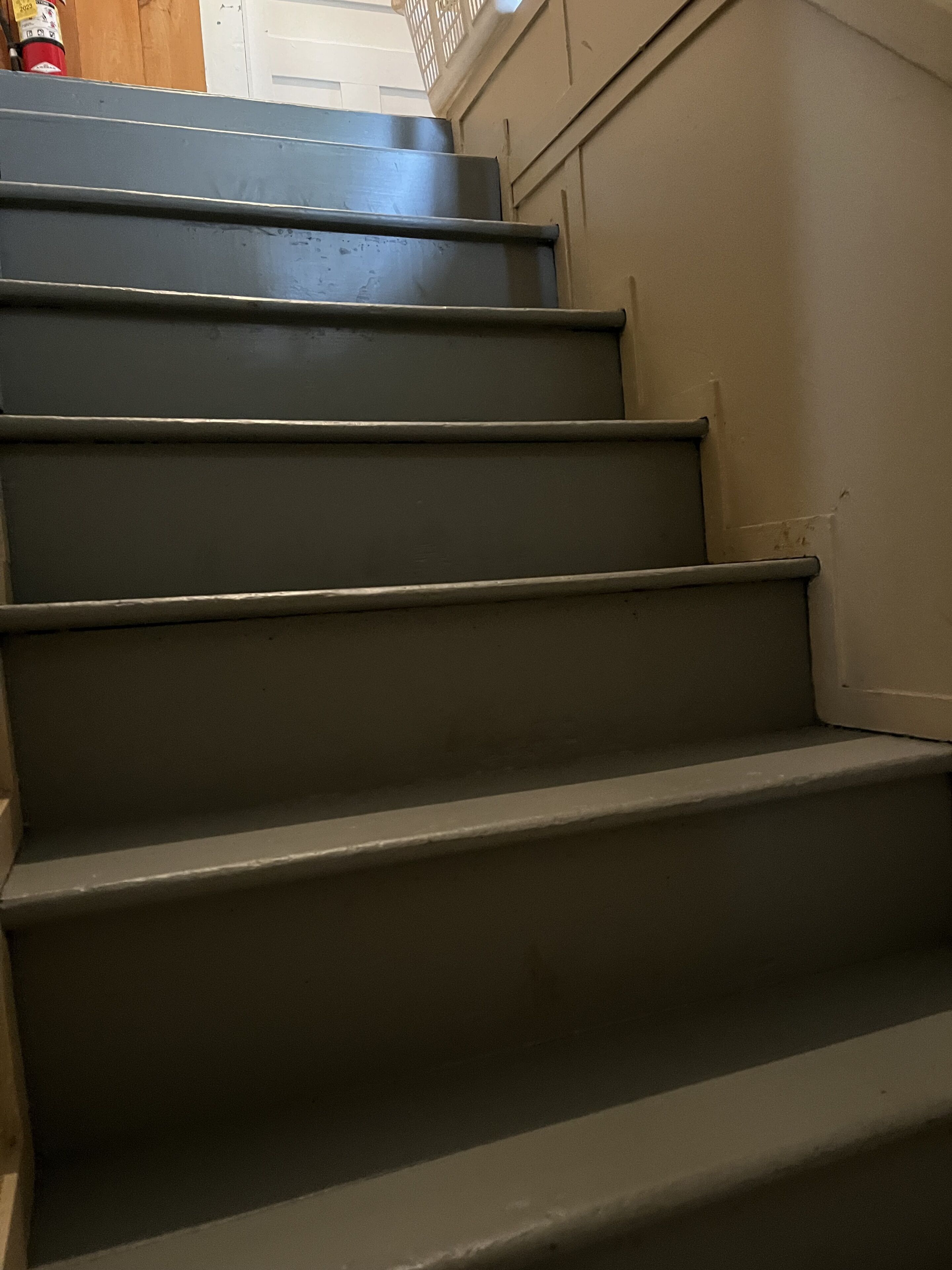 A set of dark-colored stairs leading upwards.