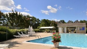 A swimming pool with lounge chairs and a small building, surrounded by trees and a clear sky. - Family Friendly Townhome in desired Stewards Watch Community- 5mins to the beach (Bethany Beach)