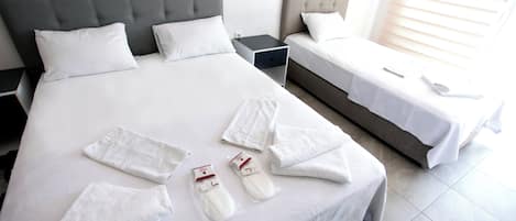 Economy Triple Room | Minibar, bed sheets