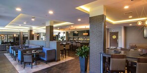A modern hotel lobby with a bar area, seating arrangements, and a reception desk. - King Suite | Free Breakfast. Pool Access. (Carlsbad)