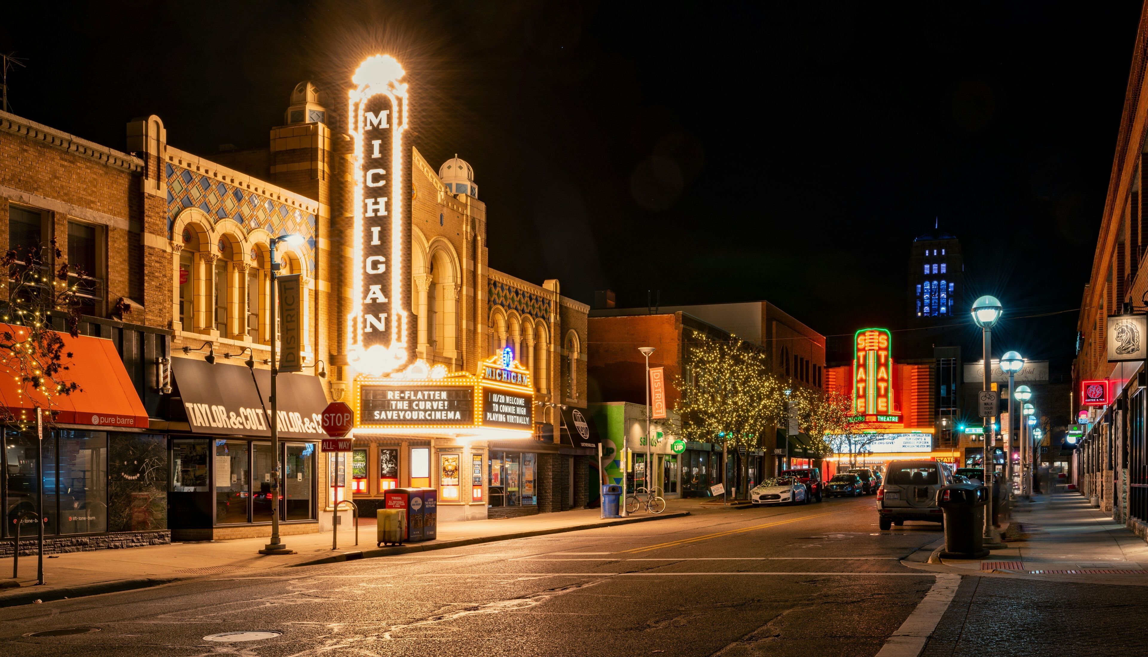 A street view at night with a theater named "Michigan" prominently lit up.