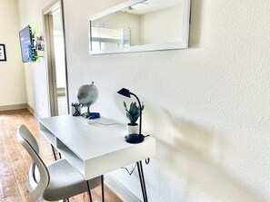 Work in comfort with a dedicated workspace featuring a desk, globe, and potted plant.