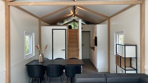 A compact living space with a dining area, a sofa, and a kitchenette. - Awesome home in Putten with WiFi (Putten)
