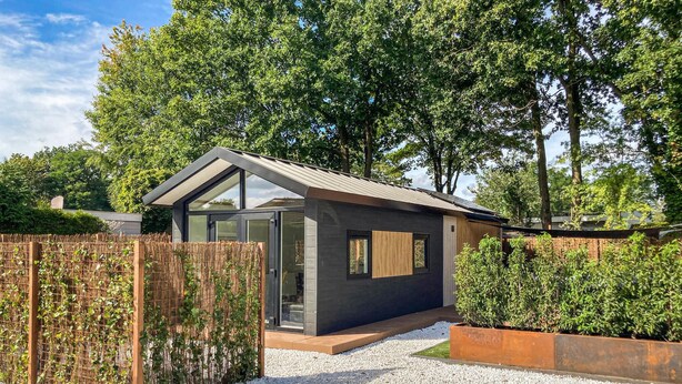 A modern, compact house with a sloped roof, large windows, and a gravel driveway. - Awesome home in Putten with WiFi (Putten)