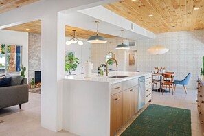 Enjoy cooking and entertaining in this well-equipped kitchen with a central island, sink, and ample counter space.